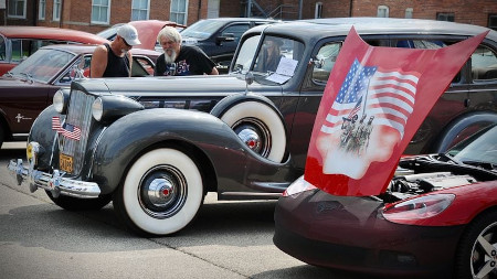 Veterans inspect a classic car at a car show