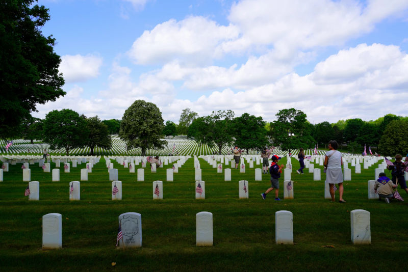 Scouts planting flags on graves in Dayton National Cemetery
